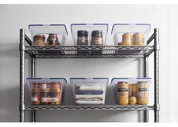Industrial wire shelving unit in a basement or utility room, full of storage bins